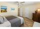 Bedroom features a bed, wooden furnishings, neutral walls and ensuite bathroom doorway at 13807 N Garden Court Dr, Sun City, AZ 85351