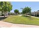 Well-manicured community green space featuring mature trees and inviting pathways at 13807 N Garden Court Dr, Sun City, AZ 85351