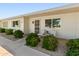 Inviting single-story home features a charming front porch with seating and manicured landscaping at 13807 N Garden Court Dr, Sun City, AZ 85351