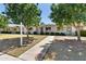 Charming single-story home with well-manicured lawn, mature trees, and a welcoming walkway at 13807 N Garden Court Dr, Sun City, AZ 85351