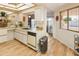 Bright kitchen showcases wood-look floors, white appliances, and access to the dining area at 13807 N Garden Court Dr, Sun City, AZ 85351