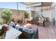 Relaxing patio space featuring comfortable seating, plants, a cozy fire pit and an outdoor rug at 13807 N Garden Court Dr, Sun City, AZ 85351