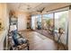 Open sunroom with wood-look floors, lots of sunlight, and a view of the relaxing patio at 13807 N Garden Court Dr, Sun City, AZ 85351