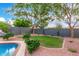 Expansive backyard with manicured lawn, mature landscaping, and shade trees at 139 E Gail Dr, Gilbert, AZ 85296