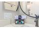 Close-up of bathroom vanity with black faucet, countertop toiletries, and framed mirror at 139 E Gail Dr, Gilbert, AZ 85296