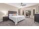 Spacious bedroom with modern ceiling fan and a separate desk area with windows at 139 E Gail Dr, Gilbert, AZ 85296