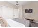 Bedroom featuring double closets, TV, and gray color palette at 139 E Gail Dr, Gilbert, AZ 85296