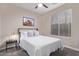 Neutral bedroom with a white bed set, a bedside table and modern black frame art at 139 E Gail Dr, Gilbert, AZ 85296