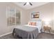 Comfortable bedroom with large window and decorative bedside lamp and artwork at 139 E Gail Dr, Gilbert, AZ 85296