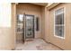Covered entryway featuring a modern steel entry door with sidelights and stacked stone pavers at 139 E Gail Dr, Gilbert, AZ 85296