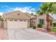 Charming home with a two car garage, desert landscaping, a mature palm tree and extended driveway at 139 E Gail Dr, Gilbert, AZ 85296