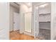 Hallway featuring access to shower and toilet rooms, as well as a walk-in closet at 139 E Gail Dr, Gilbert, AZ 85296