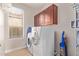 Well-equipped laundry room boasts a washer, dryer, and overhead storage at 139 E Gail Dr, Gilbert, AZ 85296