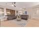 Bright living room featuring plush leather seating, decorative rug, and three ceiling fans at 139 E Gail Dr, Gilbert, AZ 85296