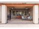 Covered patio featuring ceiling fans, a dining table, an outdoor grill, and comfortable seating at 139 E Gail Dr, Gilbert, AZ 85296