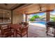 Covered patio with a wood ceiling overlooking a backyard pool and landscaping at 139 E Gail Dr, Gilbert, AZ 85296