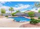 Backyard pool with an umbrella in the center and desert landscaping at 139 E Gail Dr, Gilbert, AZ 85296