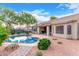 Backyard pool with mature landscaping and a pebble border at 139 E Gail Dr, Gilbert, AZ 85296