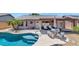 Inviting backyard showcasing a sparkling pool, spa, patio set, and lush tropical landscaping at 15740 N 91St Dr, Peoria, AZ 85382