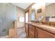 Bathroom featuring double sink vanity, framed shower and a large mirror at 15740 N 91St Dr, Peoria, AZ 85382