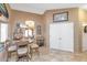 Charming breakfast nook features a round table, travertine flooring and arched doorway to the rest of the home at 15740 N 91St Dr, Peoria, AZ 85382