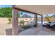 Relaxing covered patio features lounge chairs, ceiling fan, and view of the sparkling pool at 15740 N 91St Dr, Peoria, AZ 85382
