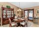 Dining room with wood table, china cabinet, and view to the backyard at 15740 N 91St Dr, Peoria, AZ 85382