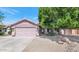 Charming single-story home with a two car garage and desert landscaping at 15740 N 91St Dr, Peoria, AZ 85382