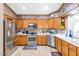 Well-lit kitchen with stainless steel appliances, tile floor, and white countertops at 15740 N 91St Dr, Peoria, AZ 85382