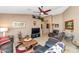 Cozy living room with travertine floors, comfortable seating, and decor at 15740 N 91St Dr, Peoria, AZ 85382