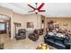 Comfortable living room with tile floors, ceiling fan, and natural light at 15740 N 91St Dr, Peoria, AZ 85382