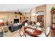 Open-concept living space with travertine floors, and dining area at 15740 N 91St Dr, Peoria, AZ 85382