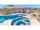 Backyard with a beautiful pool, spa, and covered patio at 15740 N 91St Dr, Peoria, AZ 85382