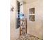 Walk-in shower features a multi-setting shower column, built-in shelving, and mosaic tile at 15740 N 91St Dr, Peoria, AZ 85382