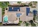 Aerial view of a home featuring a pool, solar panels, and well-maintained landscaping at 16186 W Port Royale Ln, Surprise, AZ 85379