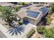 Well-maintained home with a tile roof, solar panels, and a lush green front yard at 16186 W Port Royale Ln, Surprise, AZ 85379