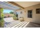 Covered back patio, perfect for outdoor living and entertaining with well manicured landscaping at 16186 W Port Royale Ln, Surprise, AZ 85379