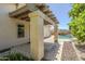 Backyard view showcasing the covered patio, desert landscaping and in-ground pool at 16186 W Port Royale Ln, Surprise, AZ 85379