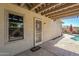 Outdoor patio area features a secure security door, with direct access to the beautiful backyard at 16186 W Port Royale Ln, Surprise, AZ 85379