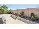 Backyard featuring benches and lush landscaping, creating a serene outdoor space for relaxation at 16186 W Port Royale Ln, Surprise, AZ 85379