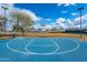 A well-maintained basketball court offers a community space for exercise and recreation, nestled among lush trees at 16186 W Port Royale Ln, Surprise, AZ 85379
