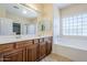 Bathroom features double sinks, soaking tub and tiled floors, offering a spa-like experience at 16186 W Port Royale Ln, Surprise, AZ 85379