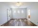 Bright bedroom featuring hard surface floors, neutral paint and ensuite bath provides comfort and style at 16186 W Port Royale Ln, Surprise, AZ 85379