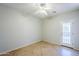 A large bedroom with tile floors and a ceiling fan at 16186 W Port Royale Ln, Surprise, AZ 85379