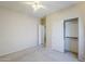 Bedroom featuring a ceiling fan and closet with sliding doors at 16186 W Port Royale Ln, Surprise, AZ 85379