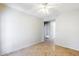 A spacious bedroom with tile flooring, ceiling fan, and neutral walls at 16186 W Port Royale Ln, Surprise, AZ 85379