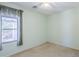 A light-filled bedroom with a ceiling fan and a bright window at 16186 W Port Royale Ln, Surprise, AZ 85379