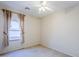 A standard-sized bedroom with a large window at 16186 W Port Royale Ln, Surprise, AZ 85379