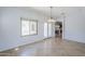 Bright dining area with tile flooring, a hanging light fixture, and backyard access at 16186 W Port Royale Ln, Surprise, AZ 85379