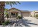 Charming single-story home featuring desert landscaping, solar panels, and a two-car garage at 16186 W Port Royale Ln, Surprise, AZ 85379
